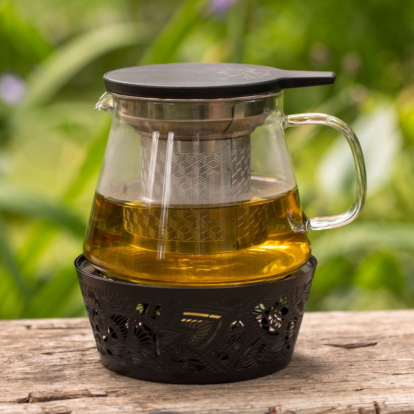 Thee infuser met kruiden in een glazen pot